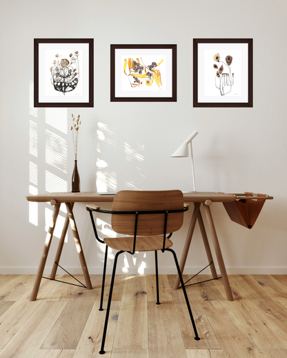 Wooden desk with chair in a room with framed artwork gallery wall