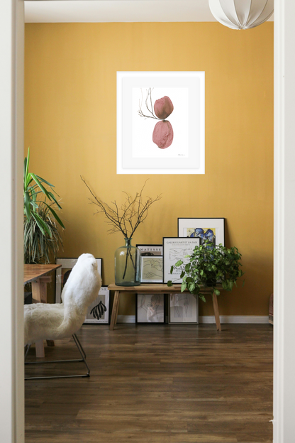 Living room with a yellow wall, framed artwork, and decorative items.